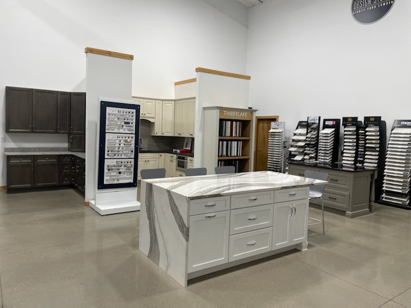 Kitchen display featuring island with white cabinets and white marble countertops