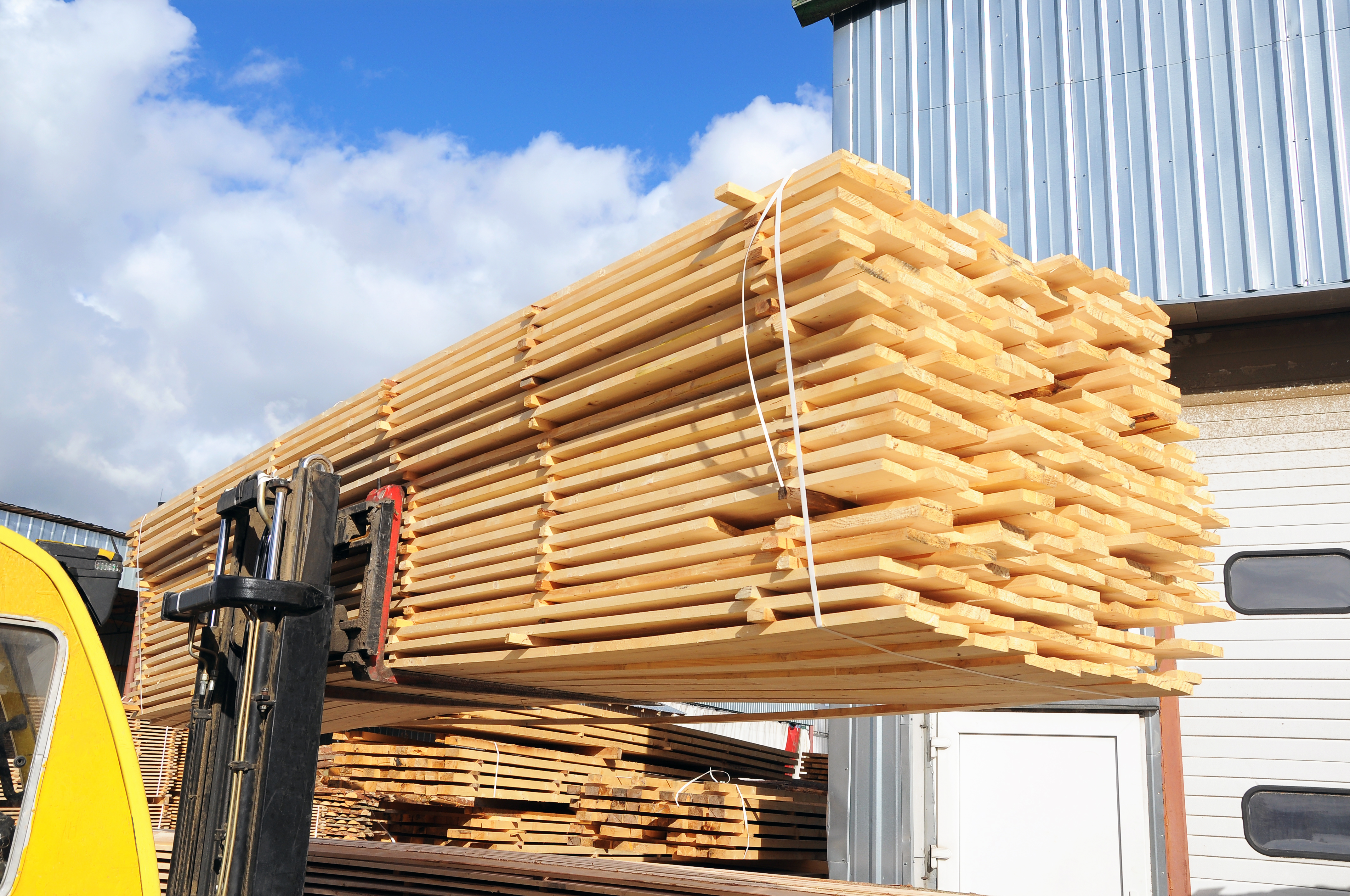 Yellow Truck Hauling Lumber 