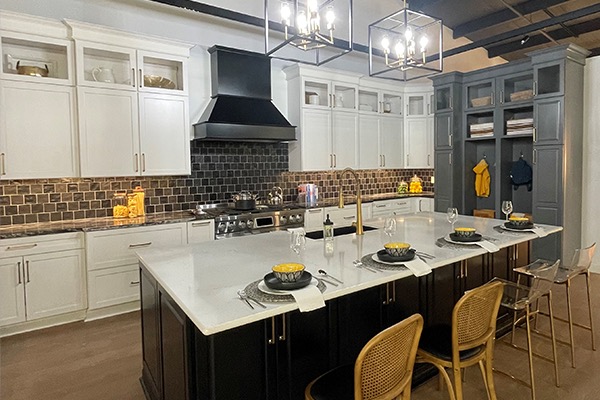 Kitchen display with dark wooden island and white and blue cabinets