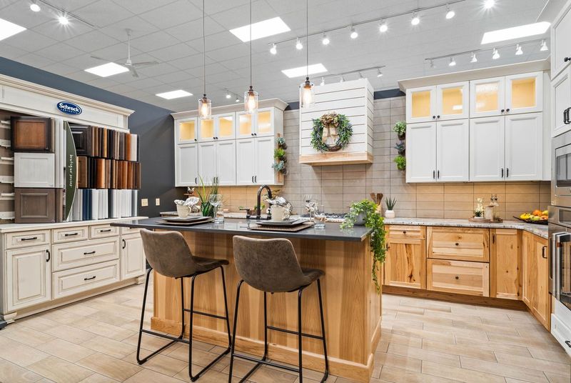 Kitchen display with white upper cabinets and wooden lower cabinets