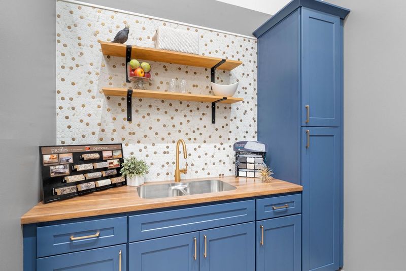 Blue cabinet display with wooden cabinets and shelving