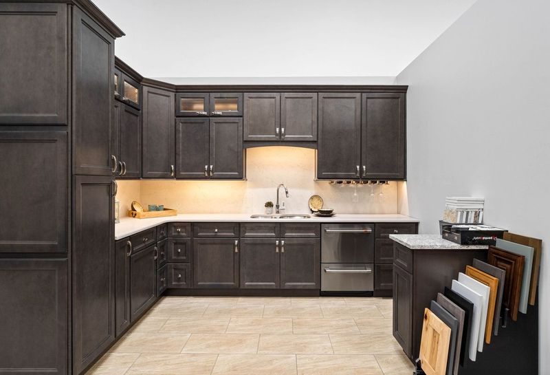 Dark brown upper and lower cabinets in kitchen display