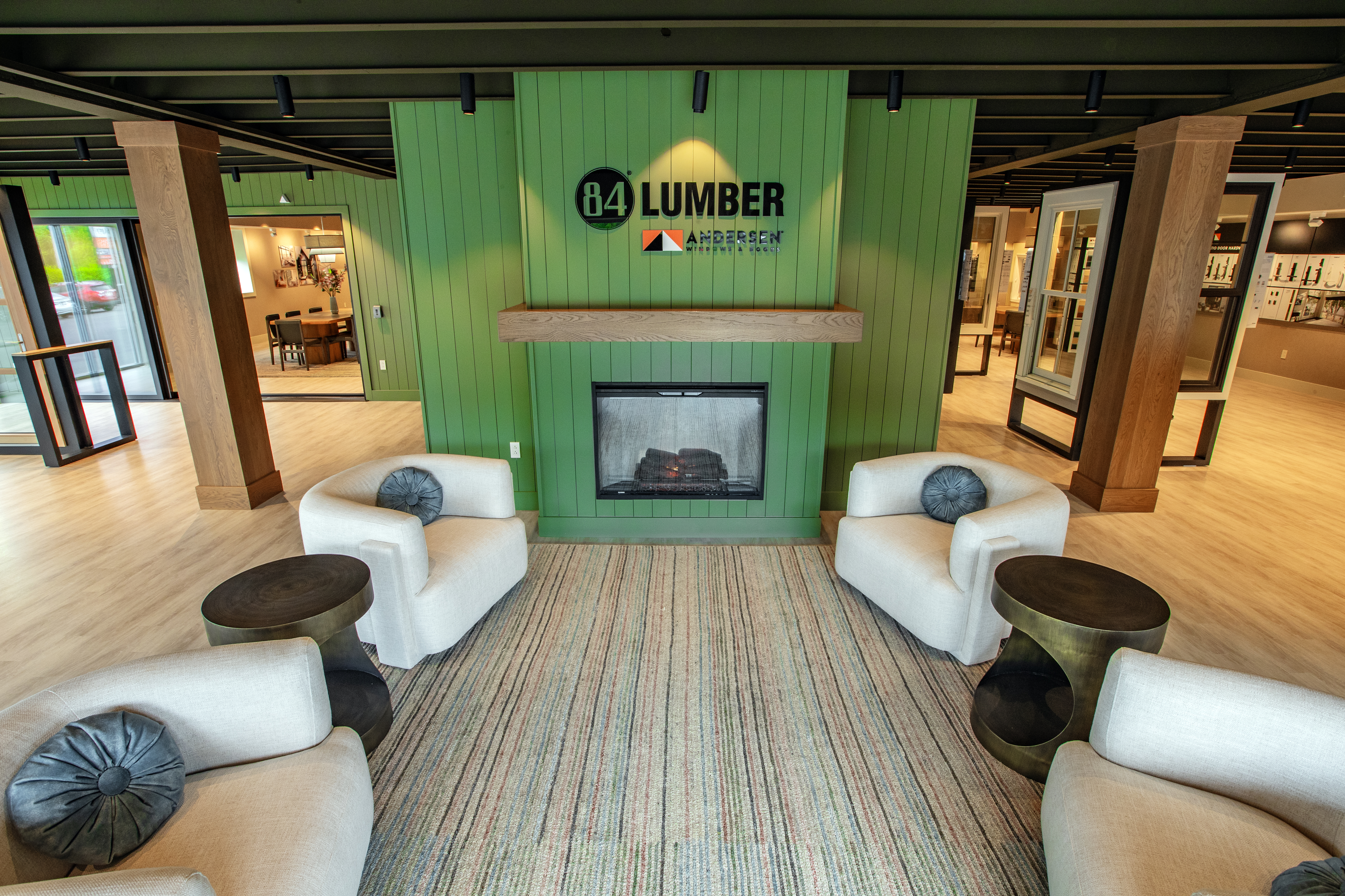 Entrance of showroom with decorative chairs and fireplace