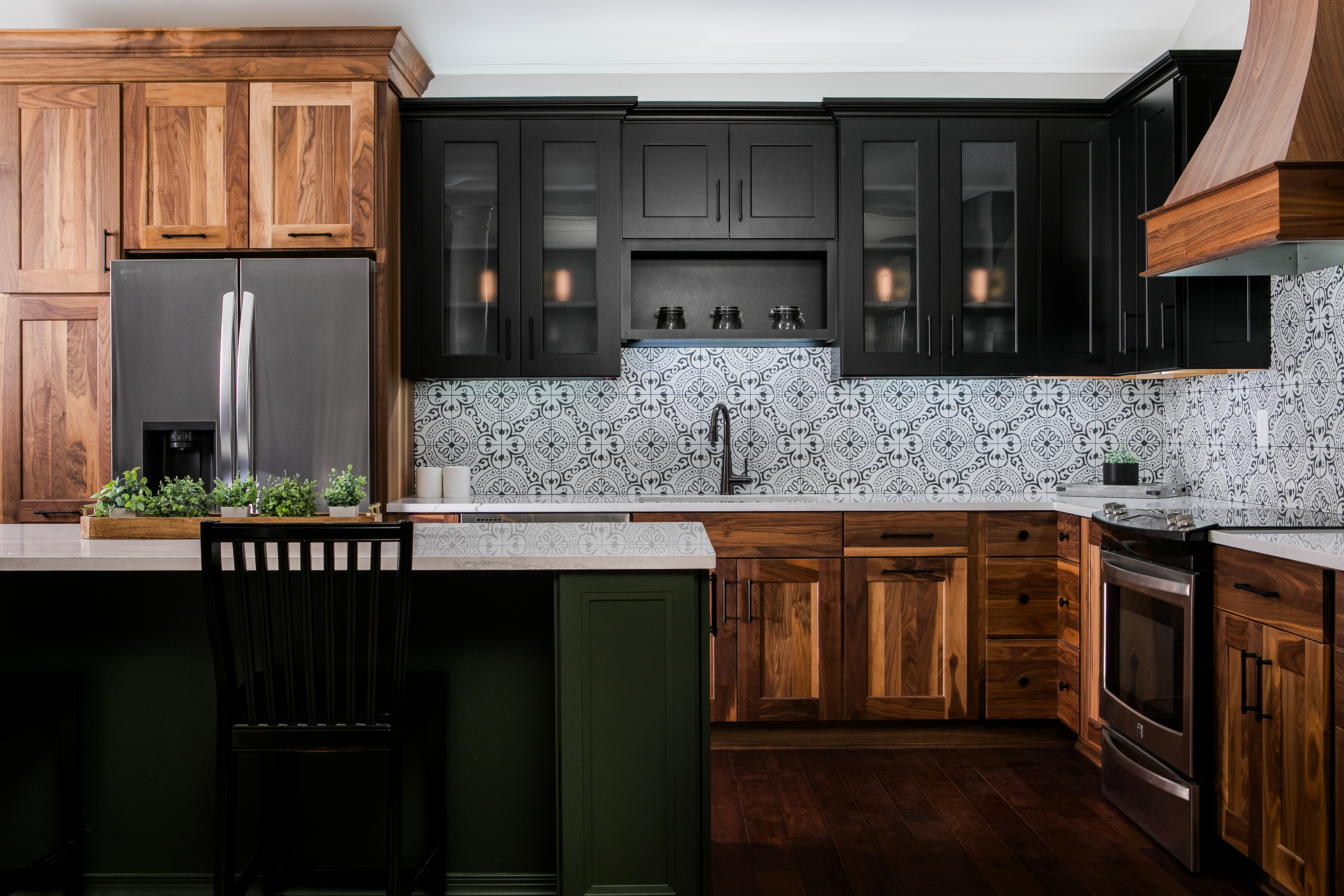 Showroom Display at 84 Lumber of a kitchen with brown wooden cabinets and a large island and wooden hood vent