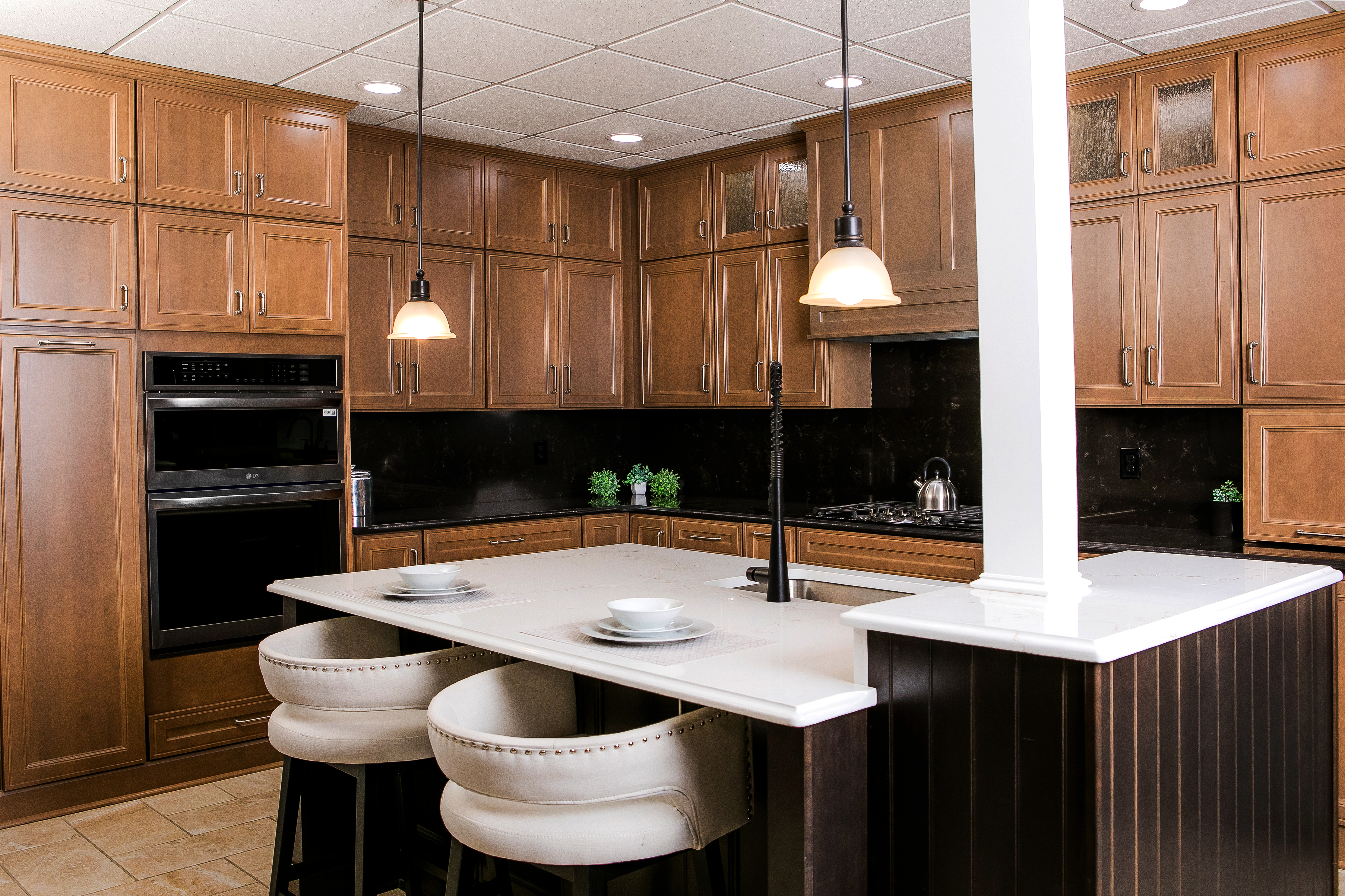 Showroom Display of a kitchen with brown wooden cabinets and a large island