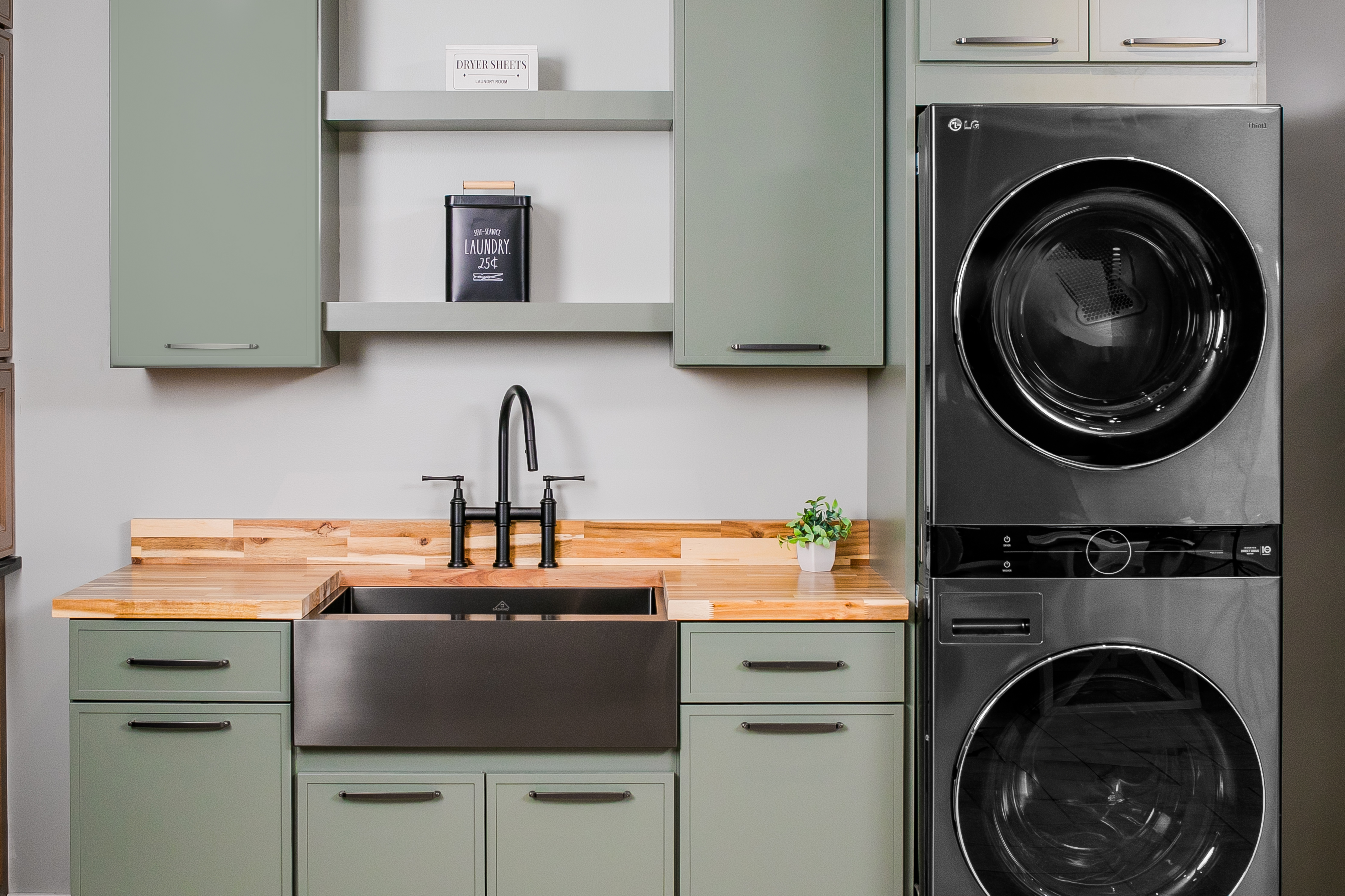 Showroom Display at 84 Lumber of a Green Cabinet Laundry Room